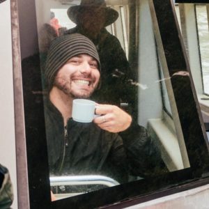 David on a boat with coffee, in new zealand